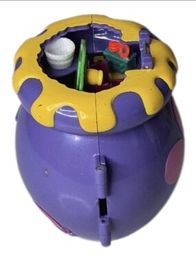 Purple & yellow plastic toy house with yellow dripping paint design